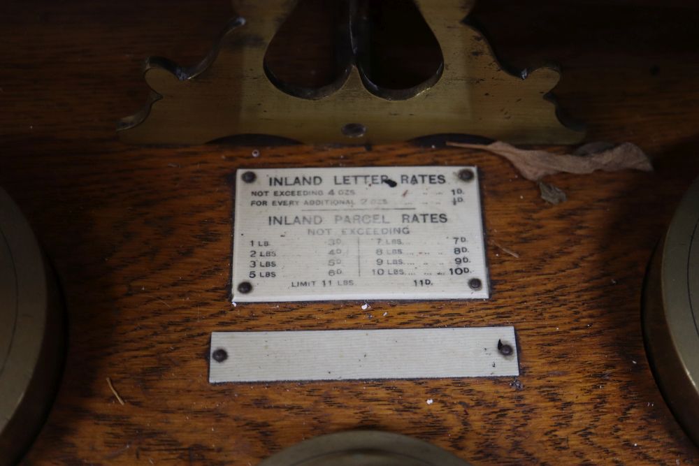 A set of large Edwardian oak and brass postal scales, base length 38cm